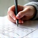 Icon illustrating a hand holding a pencil over a blueprint